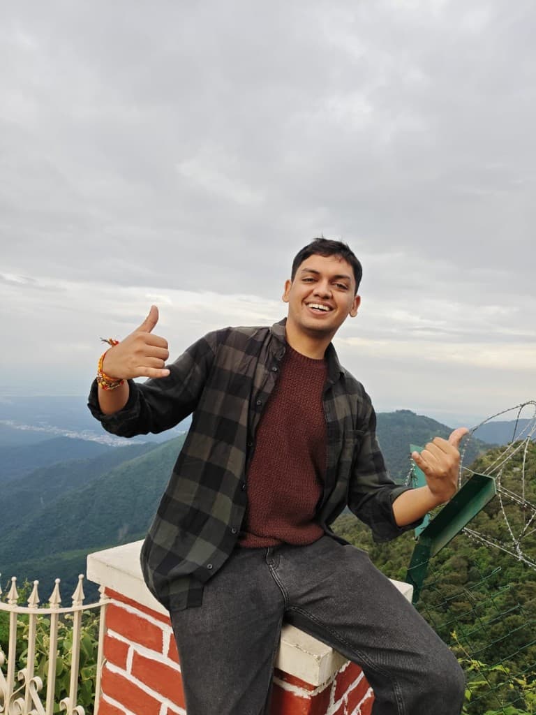 Sarthak Mittal smiling in the mountains